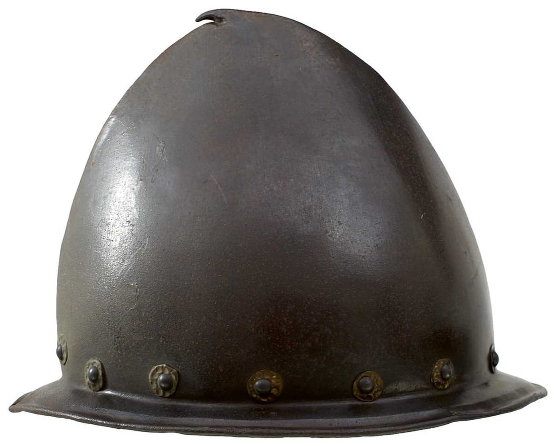 AN ITALIAN CABASET, C.1580,: AN ITALIAN CABASET, C.1580, raised from a single plate with darkened finish, distinct medial ridge rising to a pear stalk finial, brim with turned edge, the embossed brass rivet washers all well repla
