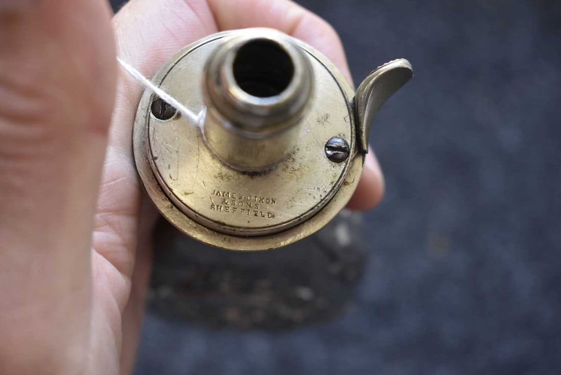 A WHITE METAL PHARAOH'S HORSES EMBOSSED POWDER FLASK,: A WHITE METAL PHARAOH'S HORSES EMBOSSED POWDER FLASK, the plated body embossed with acanthus and scrolls and a vignette to either side containing a trio of horses, the white metal top stamped QUICK LO