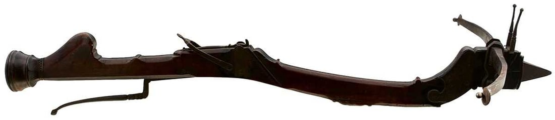 A LATE 16TH CENTURY ITALIAN STONE BOW,: A LATE 16TH CENTURY ITALIAN STONE BOW, the 27inch span steel struck with a clear armour of spade form, the curved stock carved with geometric designs, the tiller with flattened bun-shaped turned termi