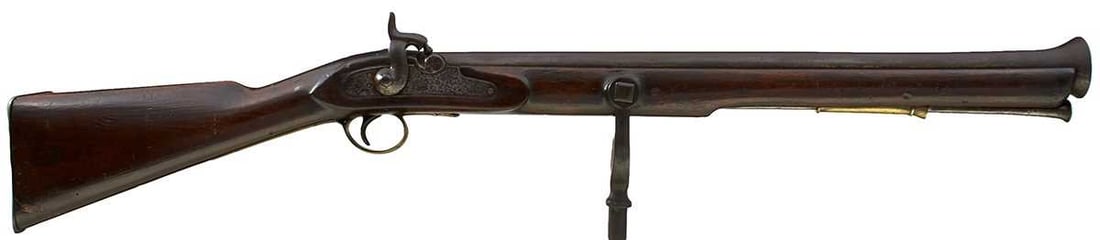 A LARGE PERCUSSION NAVAL SWIVEL GUN,: 25.5inch barrel with flared muzzle, border engraved lock stamped with a crown and TOWER across the tail, full stocked with brass mounts, iron swivel.