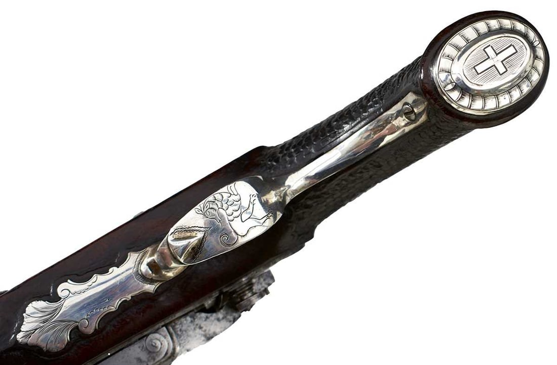 A .700 CALIBRE SPANISH OFFICER'S MIQUELET LOCK PISTOL,: 8.6inch two-stage damascus barrel inlaid in gold at the breech with star forms, fleurs des lys and a cross, a crowned R gold poincon and a second marked LONDONNIA, finely chiselled border and scroll e