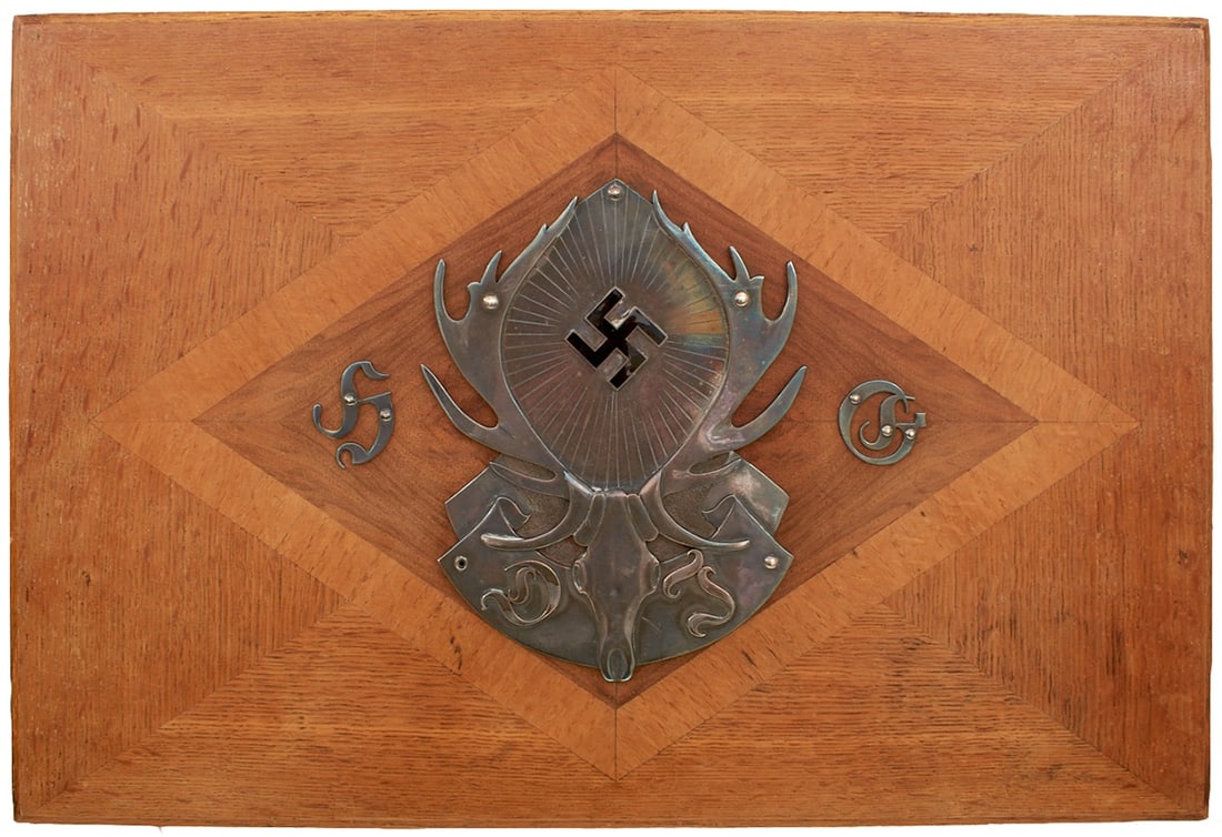 A WORLD WAR II GERMAN THIRD REICH HUNTING ASSOCIATION OR DEUTSCHE JAGERSCHAFT PRESENTATION BOX,: A WORLD WAR II GERMAN THIRD REICH HUNTING ASSOCIATION OR DEUTSCHE JAGERSCHAFT PRESENTATION BOX, of oak with geometric veneers, the hinged lid set with a large Deutsche Jagerschaft white metal emblem f