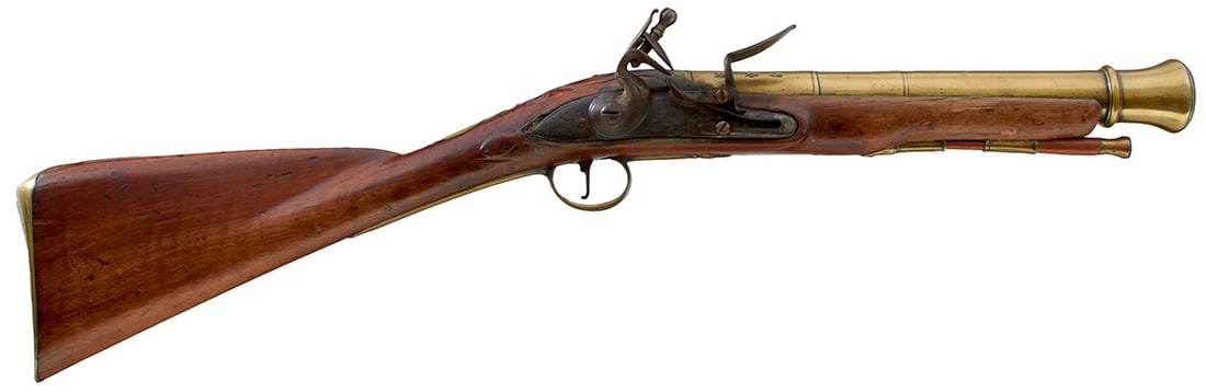 A BRASS BARRELLED FLINTLOCK BLUNDERBUSS,: A BRASS BARRELLED FLINTLOCK BLUNDERBUSS, 12inch three-stage barrel with ringed muzzle signed HEYLIN CORNHILL LONDON, foliate engraved lock, full stock with foliate engraved mounts, later brass topped 