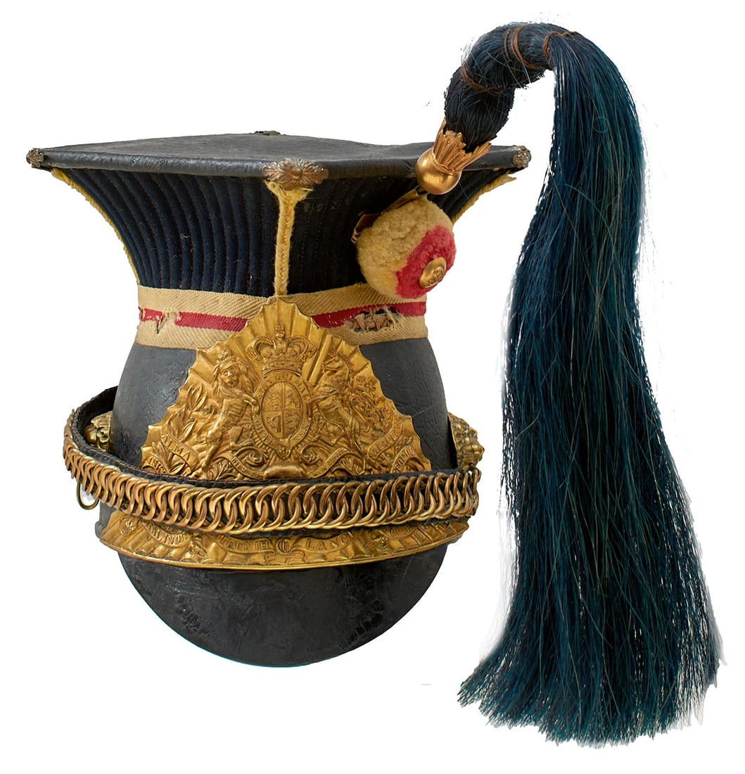 A VICTORIAN 16TH LANCERS TROOPER'S LANCE CAP,: A VICTORIAN 16TH LANCERS TROOPER'S LANCE CAP, the black leather body with associated 17th Lancers rayed helmet plate, leather top with quilted dark blue cloth support, red and yellow pompom with regim