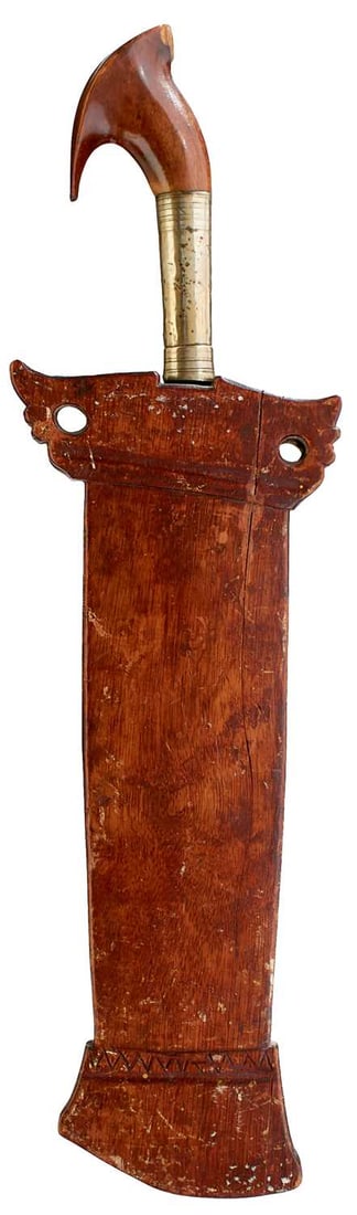 A 19TH CENTURY INDONESIAN SULAWESI KALIMANTAN BARONG OR MACHETE,: A 19TH CENTURY INDONESIAN SULAWESI KALIMANTAN BARONG OR MACHETE, 28cm heavy leaf-shaped blade, the characteristic hilt with long white metal collar and carved wooden pommel.