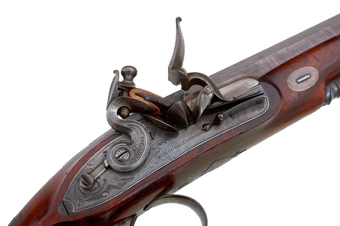 A CASED PAIR OF 20-BORE FLINTLOCK DUELLING PISTOLS BY CHARLES MOORE,: A CASED PAIR OF 20-BORE FLINTLOCK DUELLING PISTOLS BY CHARLES MOORE, 9inch sighted octagonal browned damascus barrels engraved Regent Circus PICCADILLY, platinum lined case colour hardened breeches wi