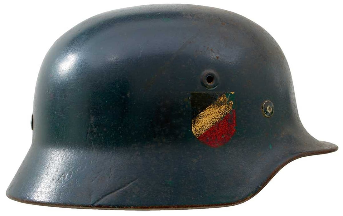 A THIRD REICH M1940 LUFTWAFFE COMBAT HELMET,: A THIRD REICH M1940 LUFTWAFFE COMBAT HELMET, the steel skull with blue over green painted finish, Luftwaffe eagle to the left side, national colours shield to the right side, the interior with green p