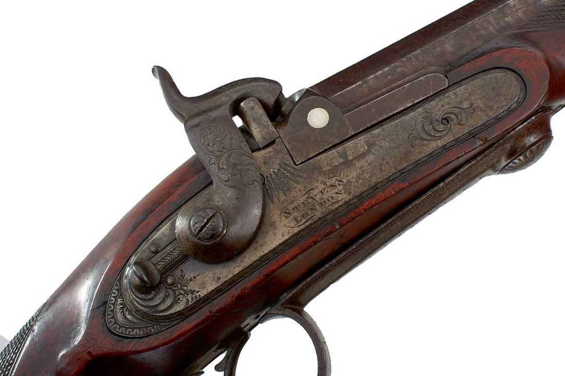 A GOOD 16-BORE PERCUSSION BREECH LOADING TAKE DOWN RIFLE BY STEVENS OF LONDON,: 33.5inch sighted browned two-stage damascus barrel engraved H. SAWYER on the top flat, border and scroll engraved bolted lock, converted from flintlock and signed STEVENS, LONDON, full stocked with de
