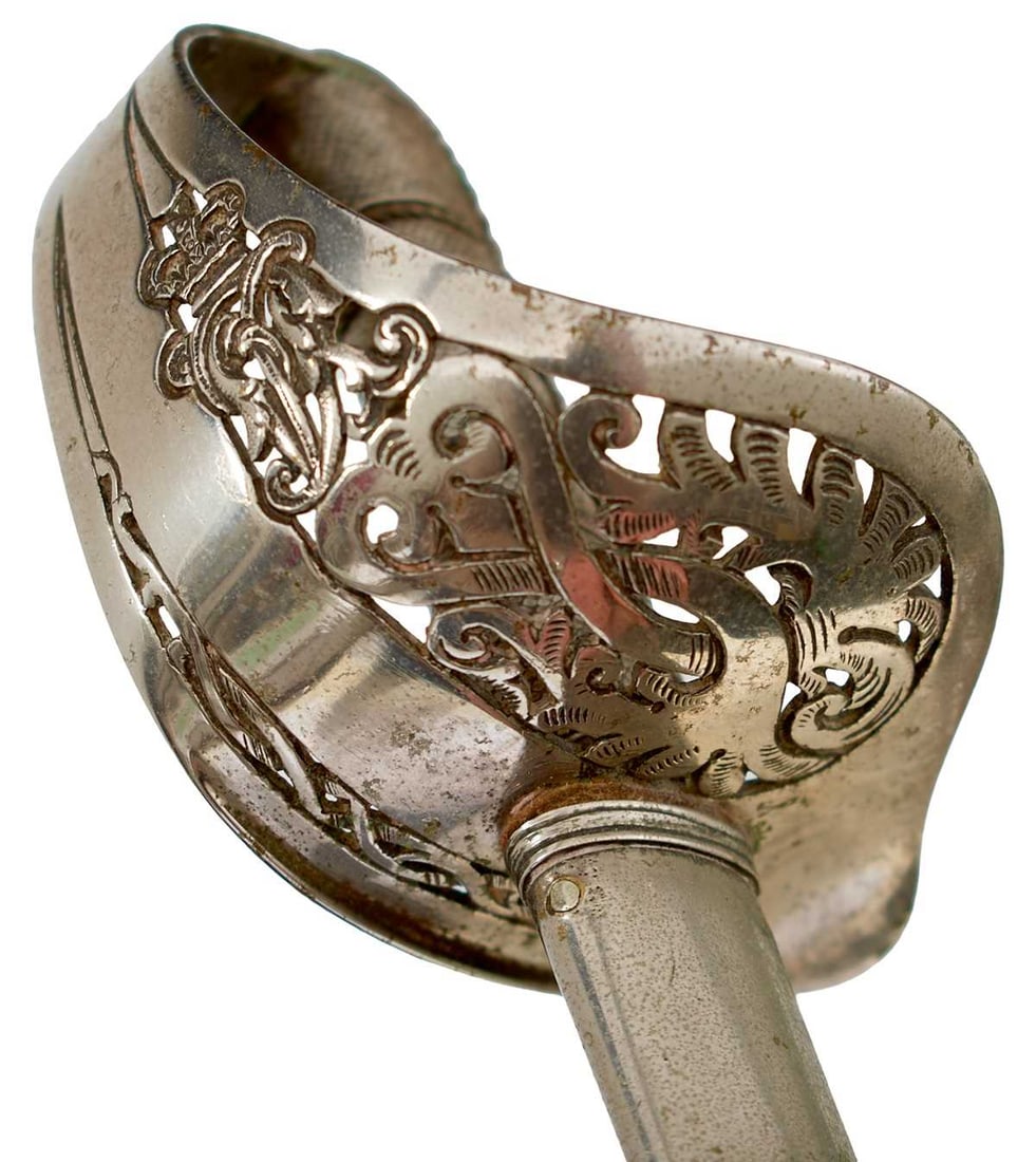 A SCARCE VICTORIAN MINIATURE 1897 PATTERN INFANTRY OFFICER'S SWORD,: 33.75cm fullered blade by John Jones & Co, Regent Street, London, etched with scrolling foliage, crowned cyphers and a set of initials, regulation pierced plated hilt incorporating a crowned VR