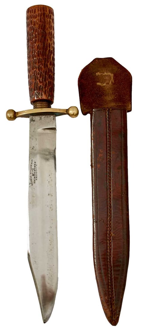 A SMALL BOWIE KNIFE BY GEORGE BUTLER,: 17.5cm clipped back blade stamped GEORGE BUTLER & CO. TRINITY WORKSHOPS SHEFFIELD, shaped brass crossguard with ball finials, tapering cylindrical horn grip with ringturned top, in its leather she