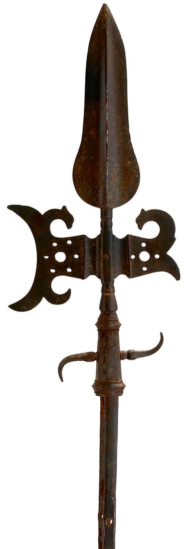 A SPONTOON OR HALBERD HEAD,: 17cm leaf-shaped head with raised medial ridge, pierced crescent-shaped head and pierced recurving fluke, faceted spurred collar with two mounting straps.