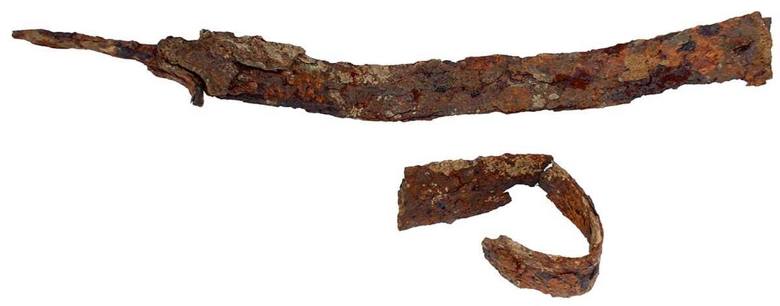 A LA TENE CULTURE RITUALLY DESTROYED LATE IRON AGE SWORD,: in excavated condition but retaining scabbard elements. From an old established English collection.