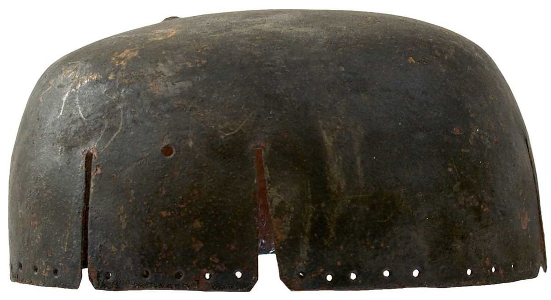 A 17TH CENTURY ENGLISH CIVIL WAR PERIOD CAVALIER'S SECRET OR HELMET,: the single piece skull with vent slits about the circumference and pieced with holes about the rim for a liner. The vendor states that this was purchased from one of the Tower of London dispersal