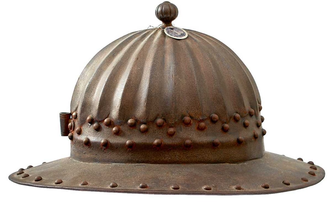 A POT OR HELMET IN THE 16TH CENTURY NORTH EUROPEAN STYLE,: the two-piece skull with radiating ribs to the top and reeded ball finial, broad brim with turned edge, the whole with rivet decoration.