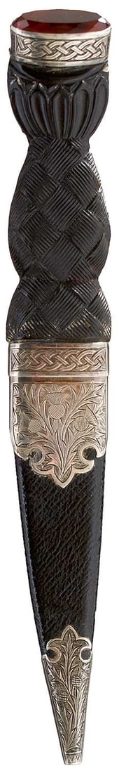 A SCOTTISH SILVER MOUNTED SGIAN DUBH,: 9cm fullered blade with partially faceted back edge, wooden grip carved with Celtic knotwork to the front and with entwined knotwork silver collar, amber coloured stone pommel, leather wrapped wooden