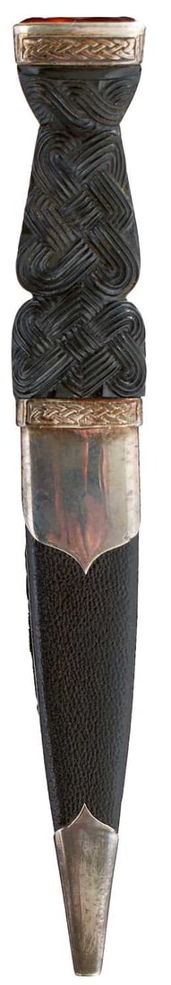 A SCOTTISH SILVER AND WHITE METAL MOUNTED SGIAN DUBH,: 9cm blade with part faceted back edge, marked STAINLESS STEEL, the white metal hilt and amber stone mounted pommel decorated with Celtic knotwork, basket weave carved wooden grip, in its silver