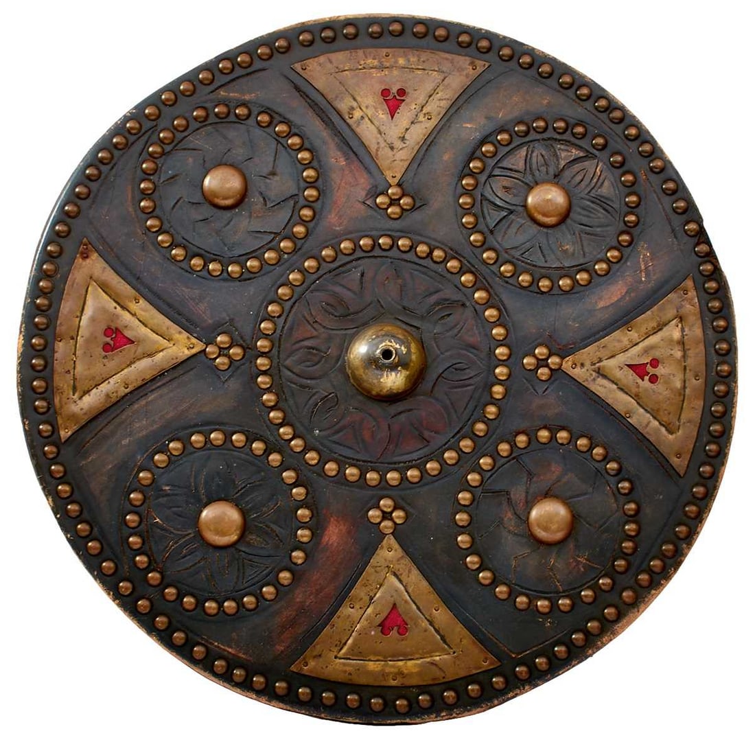 A SCOTTISH TARGE IN THE 18TH CENTURY STYLE,: 49cm diameter and leather wrapped, decorated with Celtic symbols, trimmed with brass panels and studs, chamois covered to the reverse.