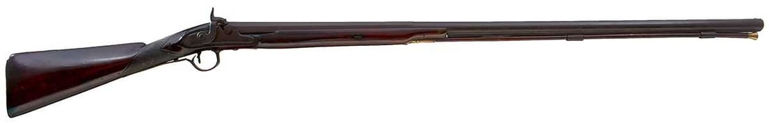 A 14-BORE PERCUSSION SPORTING GUN BY PATRICK,: 38.5inch two-stage barrel, border engraved stepped lock converted from flintlock and signed Patrick, full stock, splits, brass mounts, brass topped wooden ramrod. Damage and repairs to trigger guard.