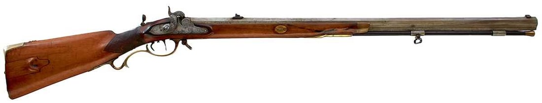 A GERMAN OR AUSTRIAN 20-BORE PERCUSSION SPORTING OR TARGET JAEGER RIFLE,: 31.5inch sighted octagonal barrel with white metal foresight and adjustable rear notch sight, border and scroll engraved lock, half stocked with chequered wrist, the butt with sliding patchbox, the ba