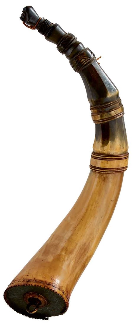 A 19TH CENTURY AMERICAN POWDER HORN,: the three-stage carved polished horn body faceted towards the nozzle, scalloped and engraved to base end, the base plug decorated with scrolling foliage and flower heads and set with a copper gilt sus