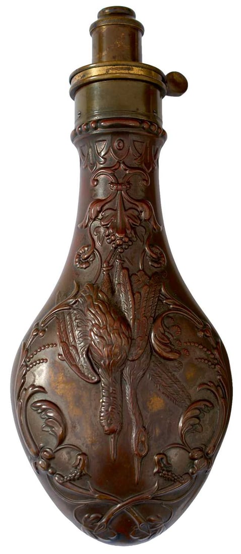 A HAWKSLEY DEAD GAME POWDER FLASK,: the embossed copper body decorated with acanthus swags and hung game, brass top with adjustable nozzle. Traces of lacquer and gilt.