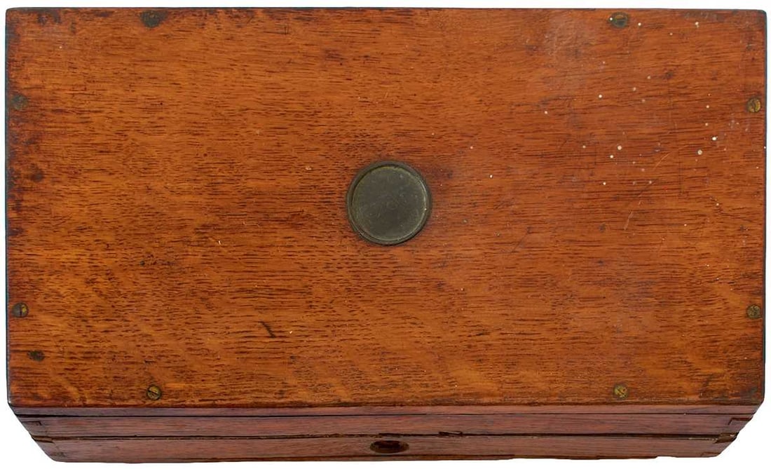 AN OAK REVOLVER CASE,: for an English percussion revolver, 17.5cm x 12.75cm, together with two pots of assocrted nipples, one of led balls and parts of two sword hilts. (Parcel)