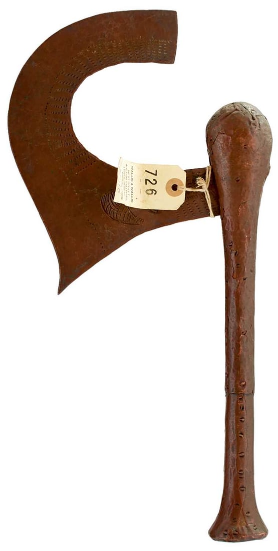 AN EARLY 20TH CENTURY CONGOLESE SONGYE TRIBE COPPER AXE,: the crescent-shaped recurving head chiselled with geometric designs and a stylised tribal figure, together with two further Songye. (3)
