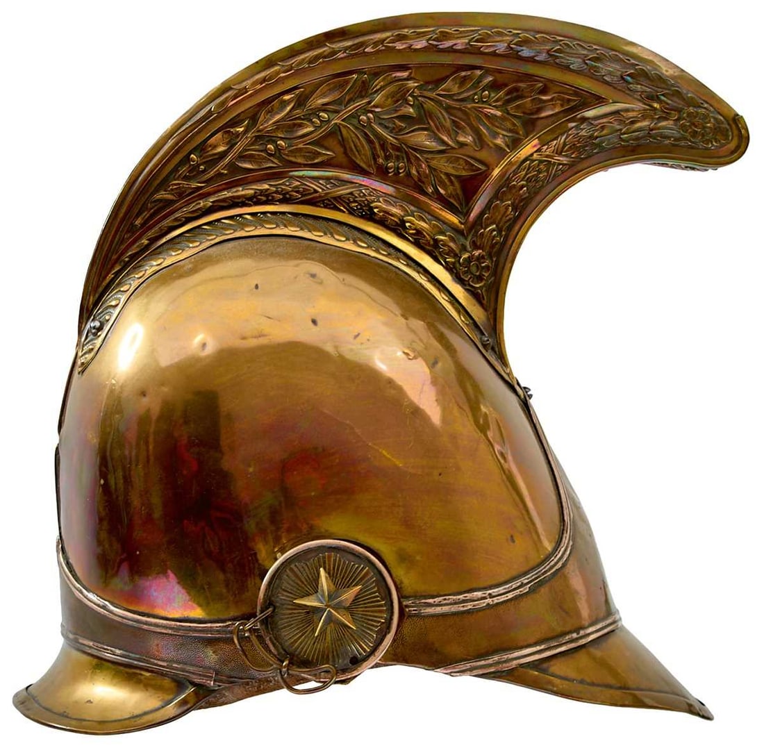 A 19TH CENTURY FRENCH DRAGOONS HELMET BY DELACHAUSSE,: the brass skull with raised comb decorated with oak leaves and laurel sprays, oak leaves to the front, helmet plate band with tramline borders and stipple ground, rayed star bosses, leather liner.