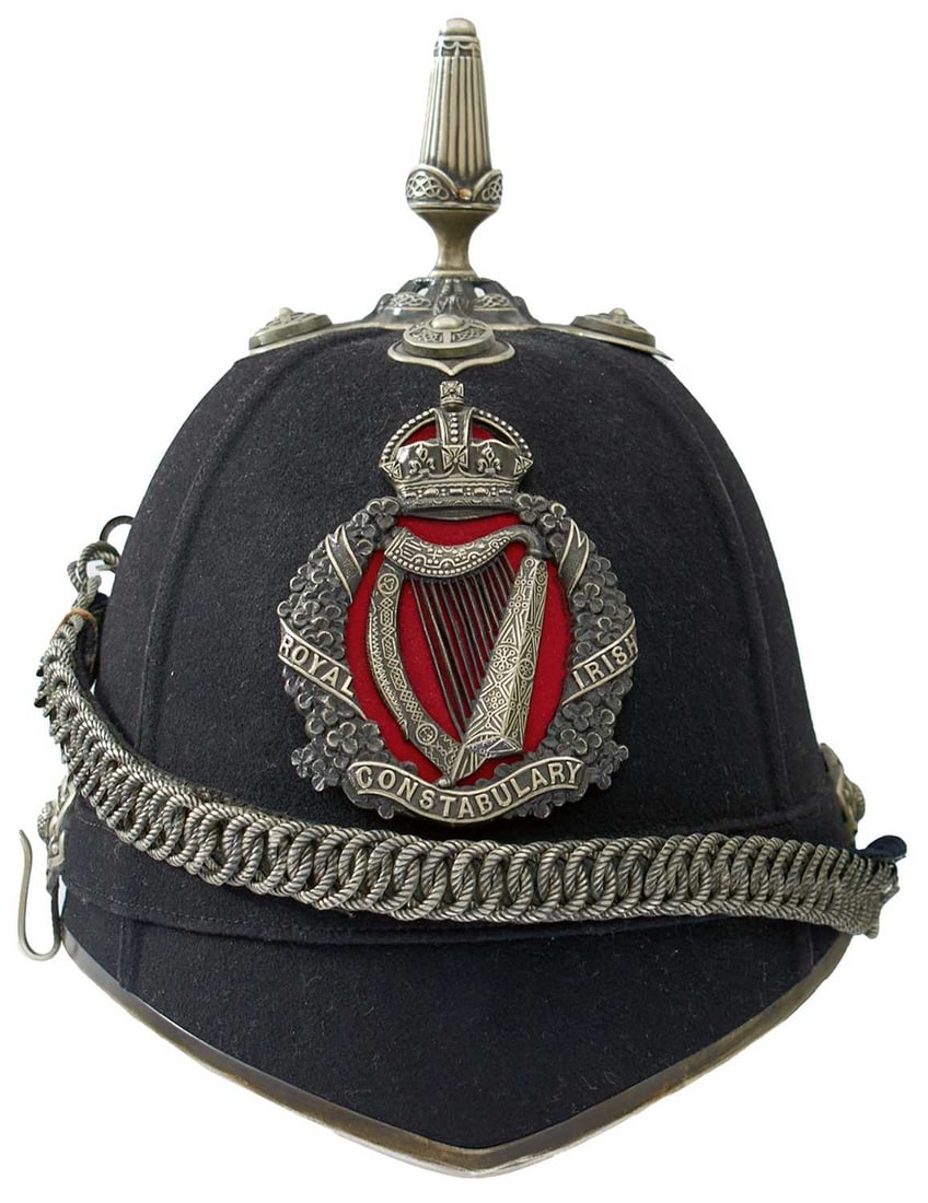 A GOOD SCARCE ROYAL IRISH CONSTABULARY OFFICER'S 1902 PATTERN BLUE CLOTH HELMET,: the dark blue cloth covered body with blacked white metal fittings, clover leaf wreath helmet plate with central harp, scroll banner ROYAL IRISH CONSTABULARY, the whole surmounted by a crown and with