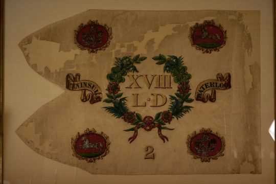 A GEORGIAN PERIOD 18TH LIGHT DRAGOONS SQUADRON HEADQUARTERS GUIDON,: the painted white silk body with the corners set with vignettes of rampant horses and wreaths of the flowers of the union and a central wreath of flowers of the union with XVIII L.D centred, the whole