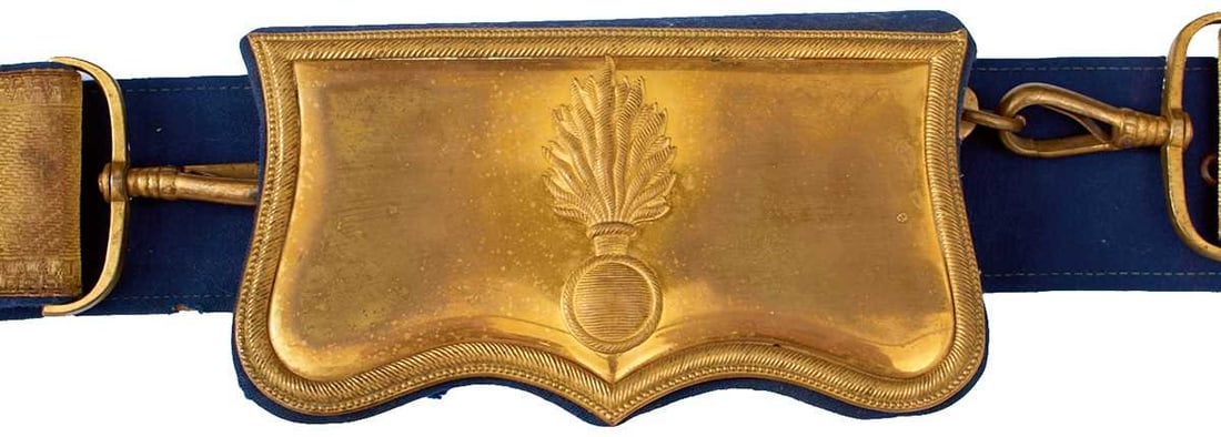 A CONTINENTAL GRENADIER'S SHOULDER BELT AND POUCH,: the gilt shaped brass flap with reeded border and applied with a flaming grenade, blue cloth covered solid wooden block pouch, blue cloth belt with bullion facings, together with another similar with