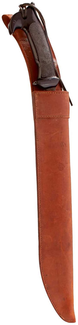 AN AMERICAN OSS OR PARATROOP COLLINS MACHETE,: 41cm blacked shaped blade, regulation chequered hard rubber grip, in its leather sheath.