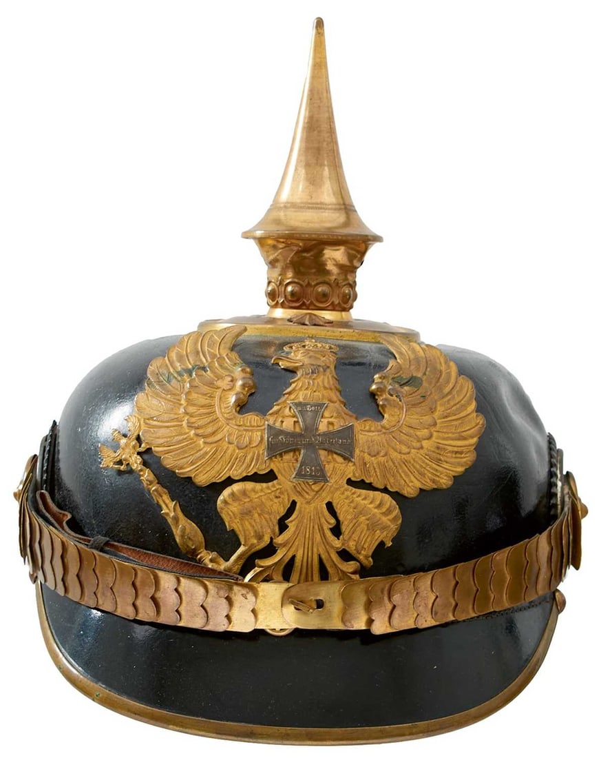 A PRUSSIAN RESERVIST OFFICER'S PICKELHAUBE,: the black leather skull with gilt brass fittings, Prussian eagle helmet plate applied with a white metal cross, spike finial, the circular plate secured with two star topped rivets, Imperial and state