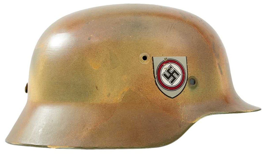 A REFURBISHED NORMANDY CAMOUFLAGE GERMAN HELMET,: the steel skull with later paint and decals, the inside with associated liner, stamped ET68 and 4378, front retaining rivets lacking, together with a reproduction German officer's tunic and cap