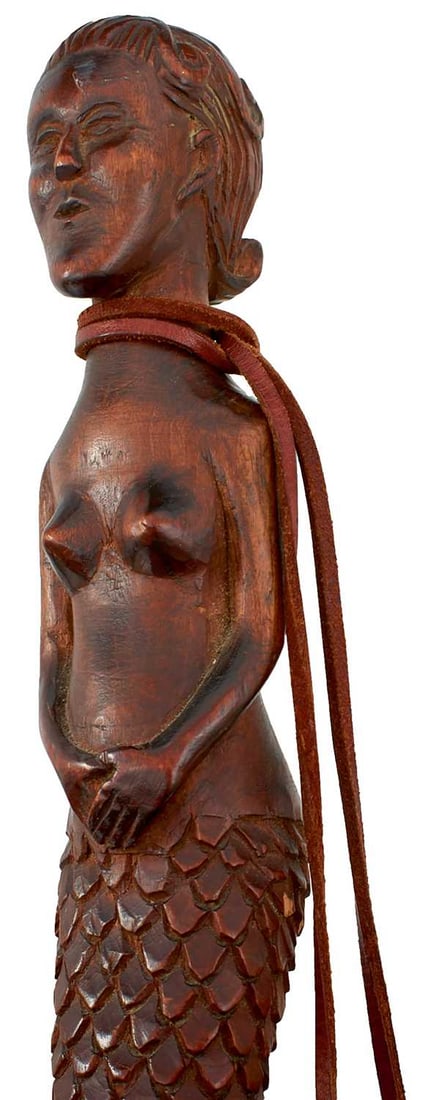 AN EARLY 20TH CENTURY PRISONER OF WAR RELATED WALKING STICK,: carved over all, surmounted by a mermaid above a serpent entwining the majority of the length of the stick interspersed with a scrolling vine, a tablet inscribed DAKENDORF DEUTSCHLAND, metal ferrule,