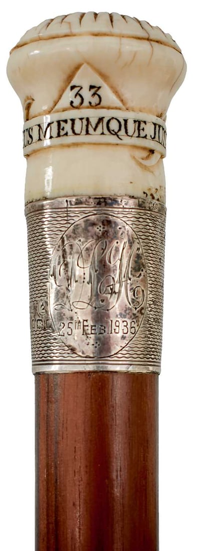 AN EARLY 20TH CENTURY MASONIC WALKING STICK,: the carved bone pommel inset with the all-seeing eye, a star and the number 33 over DEUS MEUMQUE JUS for the 33rd Degree of the Ancient and Accepted Scottish Rite, silver collar monogrammed and dated
