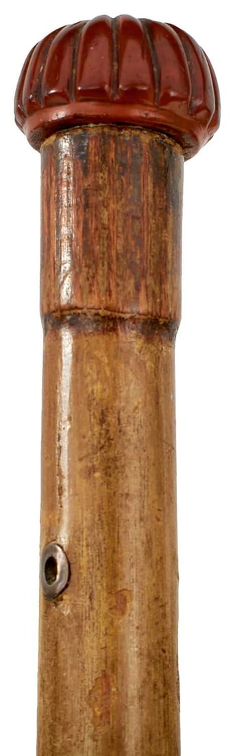 A 19TH CENTURY EUROPEAN SWORD STICK,: 74cm diamond section tapering blade decorated with geometric and foliate decorating and indistinctly inscribed in the forte, (blade and decoration worn), carved wood flattened lobed pommel with bone b