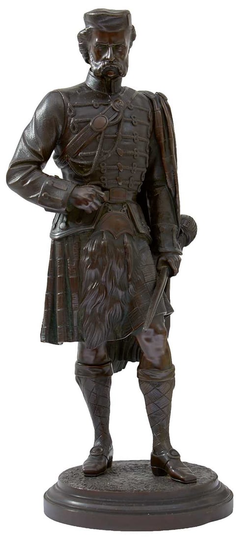 A BRONZE FULL LENGTH FIGURE OF A SCOTTISH CLANSMAN,: dressed in full regalia and holding a basket hilt, circular plinth base, 43.5cm high over all.