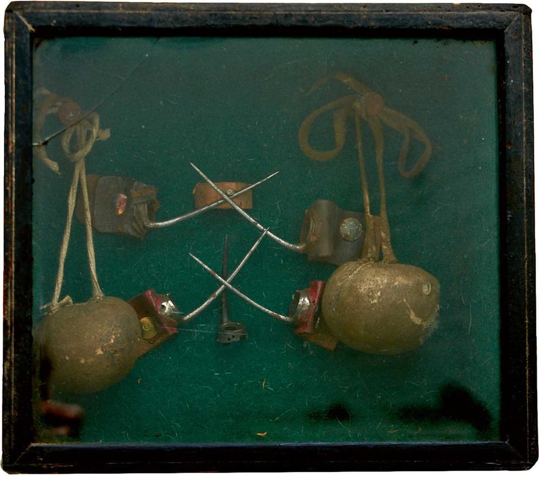 A GEORGIAN PERIOD CASE OF COCKFIGHTING EQUIPMENT,: comprising two pairs of spurs and a single spur, and two padded chamois leather balls with cords. 20cm x 18cm x 8cm, glass cracked.