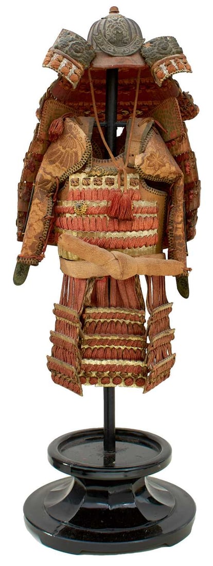 A JAPANESE MINIATURE SAMURAI ARMOUR,: A JAPANESE MINIATURE SAMURAI ARMOUR, comprising kabuto with fukigaeshi and shikoro, the do with kusauri, complete with kote, kusazuri, and uwa-obi, mounted on a frame and plinth.