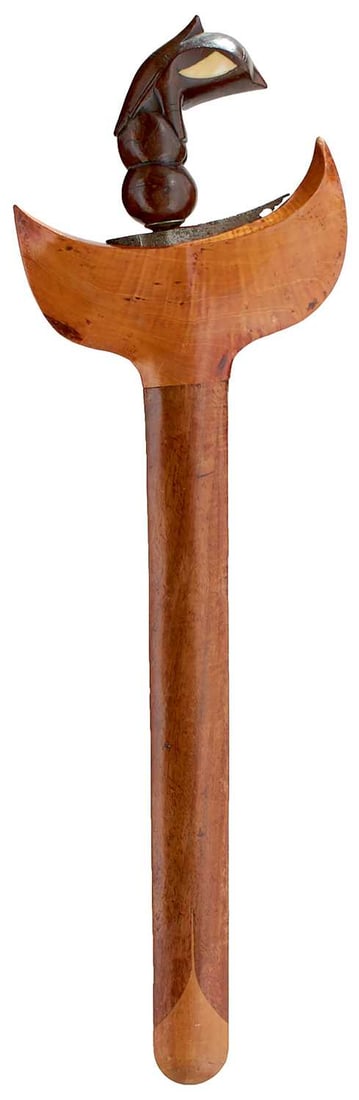 A 20TH CENTURY INDONESIAN KRIS,: A 20TH CENTURY INDONESIAN KRIS, 28cm flattened diamond section pamor blade, characteristic wooden hilt carved in the form of a Garuda with shell inserts to form the eyes, in its wooden scabbard.