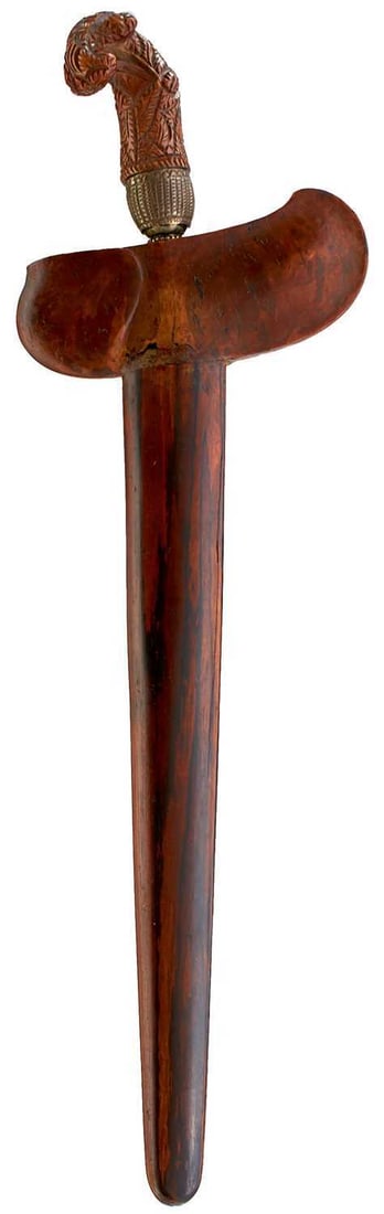 A LATE 19TH CENTURY MADURA KRIS,: A LATE 19TH CENTURY MADURA KRIS, 29.75cm straight pamor blade, characteristic carved and pierced wooden hilt, in its wooden sheath.