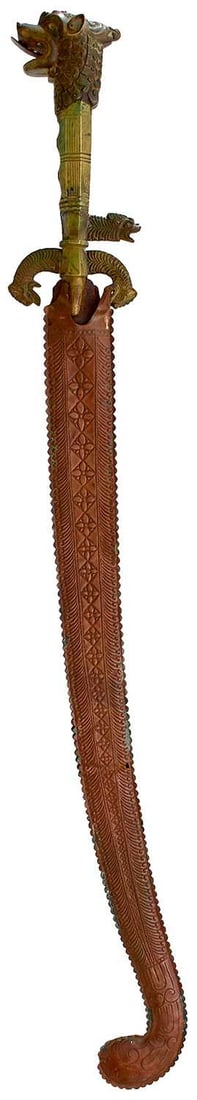 A LATE 19TH CENTURY SINHALESE OR CEYLONESE KASTANE OR SHORT SWORD,: A LATE 19TH CENTURY SINHALESE OR CEYLONESE KASTANE OR SHORT SWORD, 46cm curved blade, characteristic brass hilt with down turned quillons of Simah form, secondary quillon, large Simah head quillon, re
