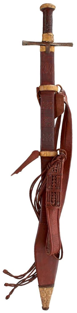 A LATE 19TH CENTURY SUDANESE KASKARA OR SWORD,: A LATE 19TH CENTURY SUDANESE KASKARA OR SWORD, 81cm triple fullered blade incised with celestial imagery and foliage, characteristic hilt with square section flared crossguard, cord bound wooden