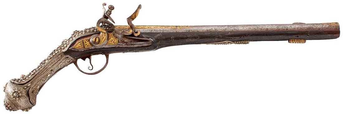 AN ORNATE 18-BORE OTTOMAN TURKISH FLINTLOCK HOLSTER PISTOL,: AN ORNATE 18-BORE OTTOMAN TURKISH FLINTLOCK HOLSTER PISTOL, 14inch sighted two-stage barrel profusely decorated with geometric designs and foliage in gold, the stepped lock and cock decorated to