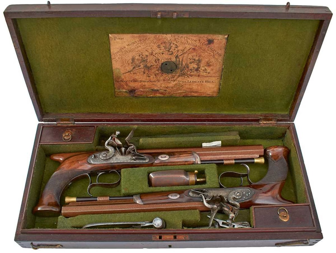 A CASED PAIR OF 25-BORE FLINTLOCK SAW-HANDLED DUELLING PISTOLS BY THOMAS MORTIMER,: A CASED PAIR OF 25-BORE FLINTLOCK SAW-HANDLED DUELLING PISTOLS BY THOMAS MORTIMER, 10inch sighted octagonal rebrowned damascus barrels with platinum lined chevron engraved stepped breeches, inset with