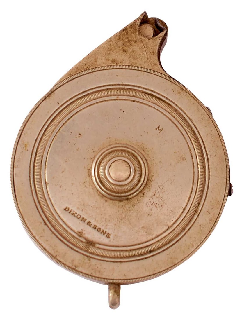 A DIXON & SONS WHITE METAL CAP DISPENSER,: A DIXON & SONS WHITE METAL CAP DISPENSER, the circular nickel body with ring turned cover and back, the former stamped with the manufacturer's details and the letter M, suspension ring, sprung top.