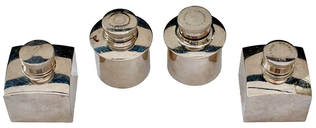 GROUP OF FOUR GUN SIZED PEWTER OIL BOTTLES,: GROUP OF FOUR GUN SIZED PEWTER OIL BOTTLES, one by Westley Richards, the other J. Purdey, both square, the remainder of cylindrical form and by Hellis & Sons and the last Cogswell & Harrison. 
