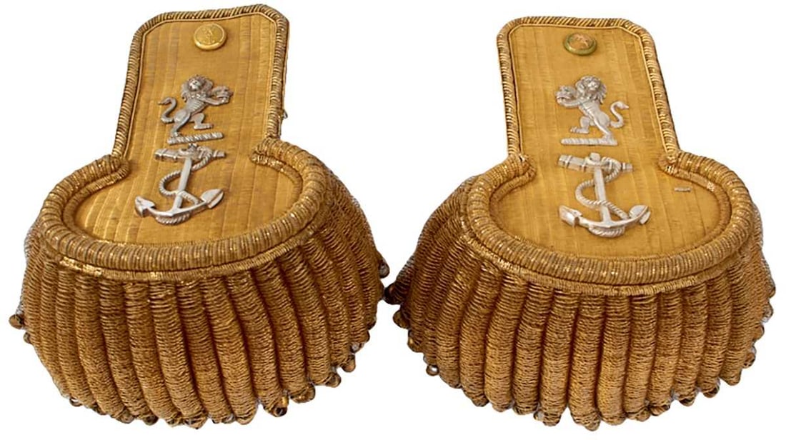 A PAIR OF EAST INDIA COMPANY NAVAL OFFICER'S EPAULETTES,: A PAIR OF EAST INDIA COMPANY NAVAL OFFICER'S EPAULETTES, the bullion boards with roped bullion borders, applied with chased white metal mounts, the EIC rampant lion over a fouled anchor, bullion tasse