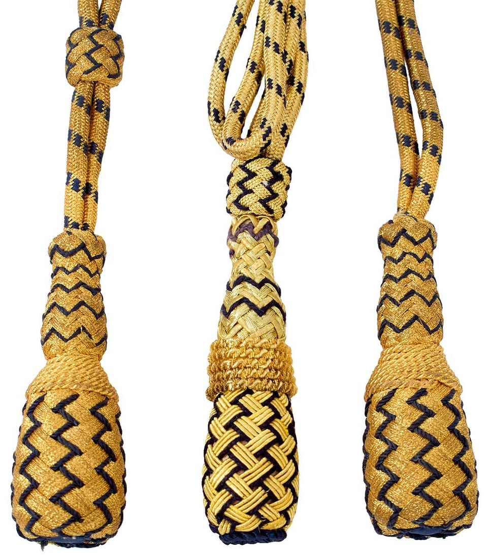 FIVE UNISSUED NAVAL OFFICER'S SWORD KNOTS,: FIVE UNISSUED NAVAL OFFICER'S SWORD KNOTS, of characteristic bullion and blue cloth form, another for a dirk, together with a Heavy cavalry officer's sword guard, another, naval, a worn tsuka from a s